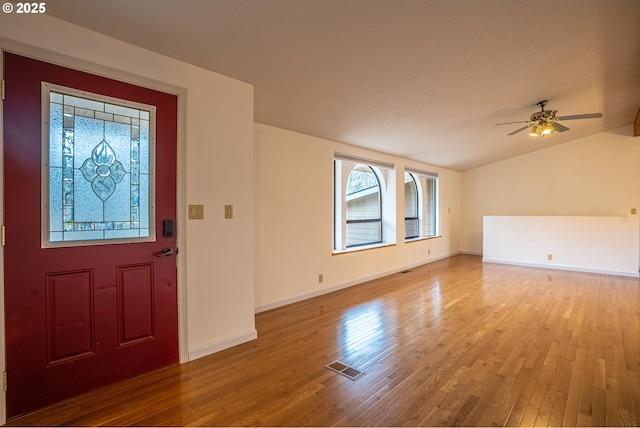 entrance foyer with ceiling fan, lofted ceiling, and light wood-type flooring