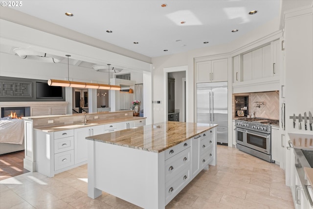 5390 NW Roanoke Ln, Portland, OR 97229 - kitchen with premium appliances, a large island, backsplash, open floor plan, and recessed lighting