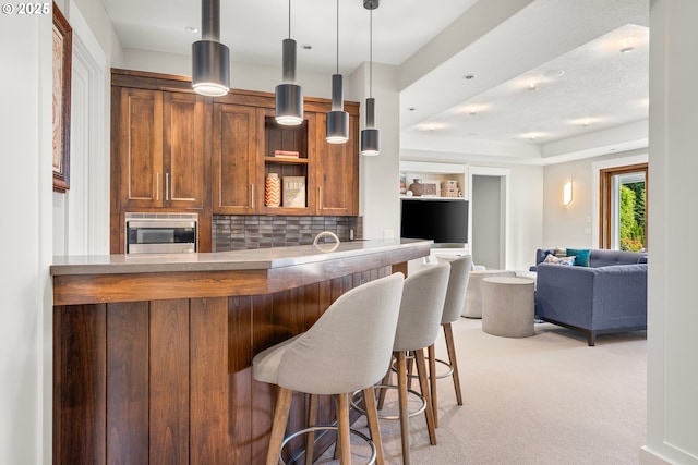 5390 NW Roanoke Ln, Portland, OR 97229 - bar featuring stainless steel microwave, light carpet, backsplash, and decorative light fixtures