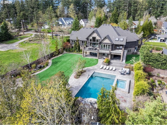 5390 NW Roanoke Ln, Portland, OR 97229 - rear view of property with a deck, a patio, an outdoor pool, and view of scattered trees