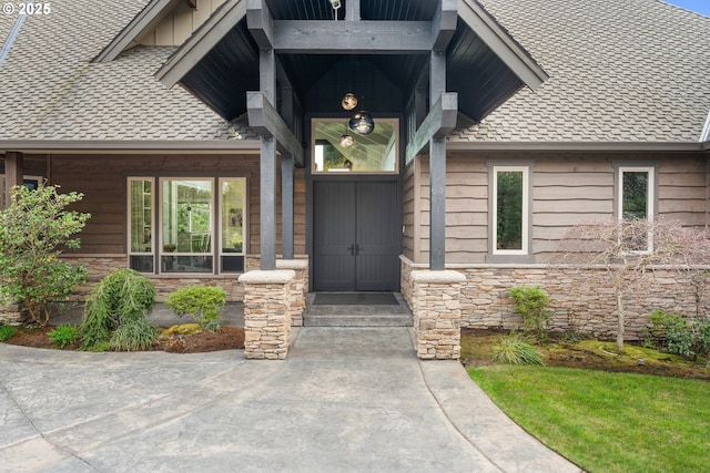 5390 NW Roanoke Ln, Portland, OR 97229 - view of exterior entry with stone siding, roof with shingles, and board and batten siding