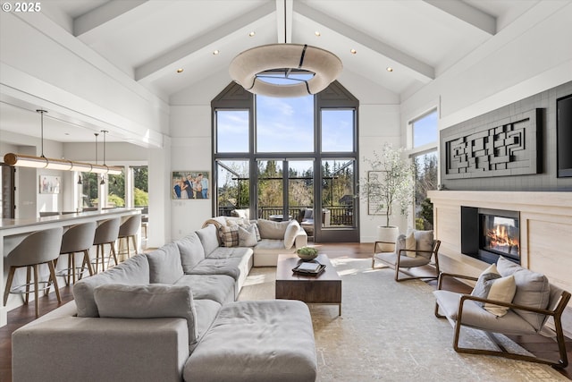 5390 NW Roanoke Ln, Portland, OR 97229 - living area featuring high vaulted ceiling, recessed lighting, beam ceiling, a premium fireplace, and wood finished floors