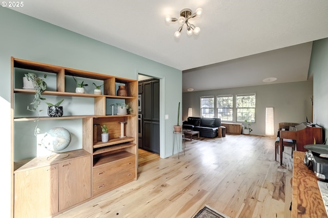 living area featuring a chandelier and light wood-type flooring