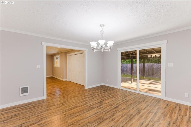 108 Lomor Dr, Longview, WA 98632 - unfurnished room featuring a chandelier, crown molding, a textured ceiling, light wood-type flooring, and baseboards