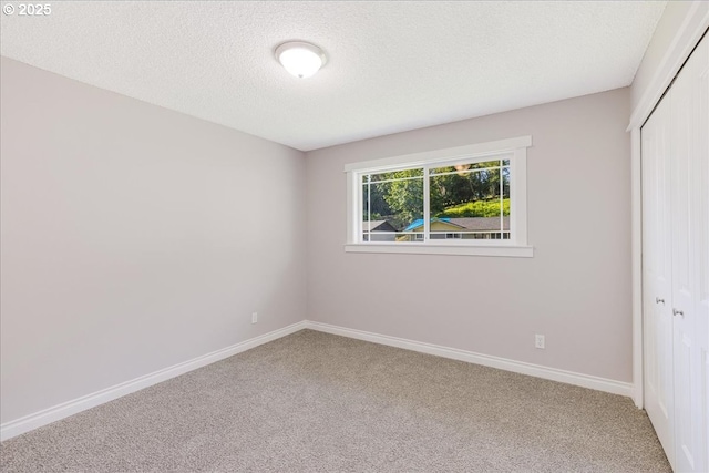 108 Lomor Dr, Longview, WA 98632 - unfurnished bedroom featuring a closet, carpet floors, baseboards, and a textured ceiling
