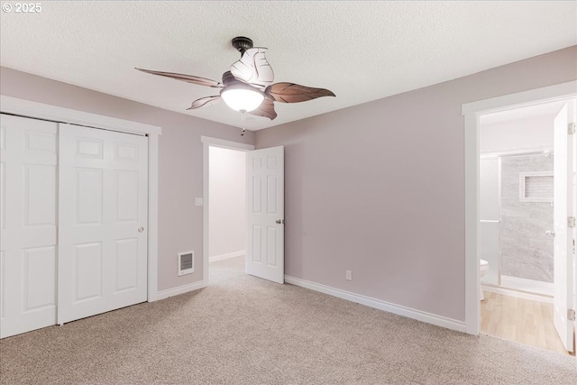 108 Lomor Dr, Longview, WA 98632 - unfurnished bedroom featuring carpet flooring, a closet, baseboards, a textured ceiling, and ensuite bath