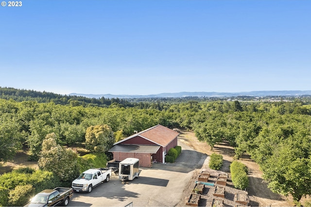view of subject property with a heavily wooded area
