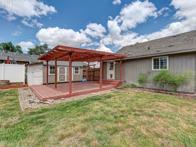 rear view of property featuring an outbuilding, a shed, a wooden deck, and fence