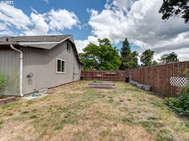 view of yard featuring a garden and a fenced backyard