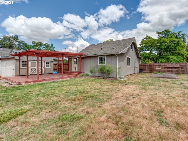 rear view of house featuring a fenced backyard, a storage unit, a lawn, and an outdoor structure