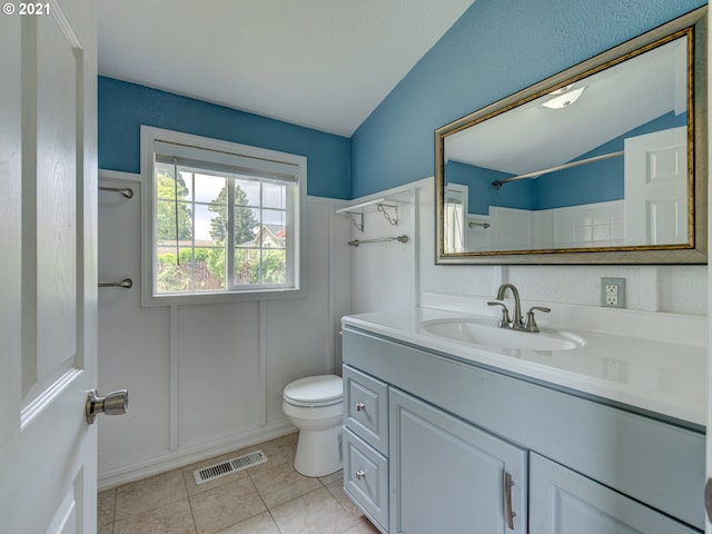 bathroom with visible vents, toilet, walk in shower, vaulted ceiling, and vanity