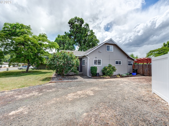 exterior space with fence and a yard