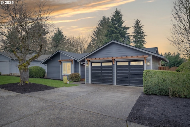 ranch-style house with a yard, driveway, and a garage