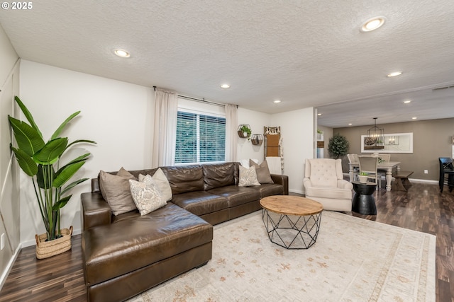 living room featuring recessed lighting, a textured ceiling, and wood finished floors