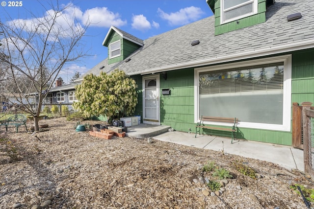 property entrance with a shingled roof