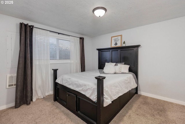 carpeted bedroom with a wall mounted AC and a textured ceiling