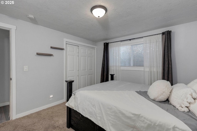 carpeted bedroom featuring a closet and a textured ceiling