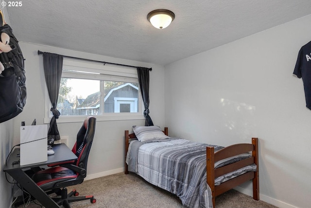 bedroom featuring a textured ceiling and light colored carpet