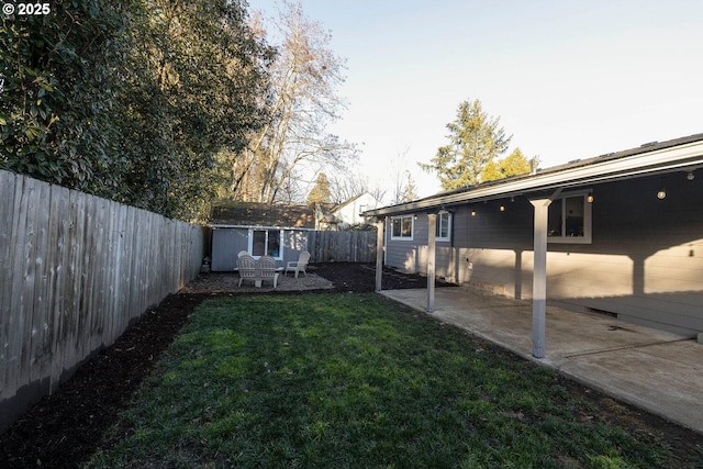 view of yard with a patio and a shed