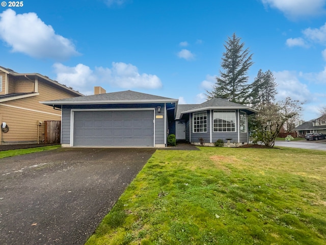 single story home featuring an attached garage, a chimney, driveway, and a front yard