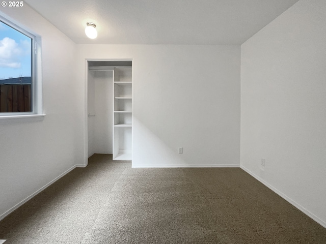 unfurnished bedroom featuring baseboards and carpet