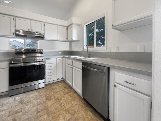 kitchen with under cabinet range hood, appliances with stainless steel finishes, white cabinetry, and a sink