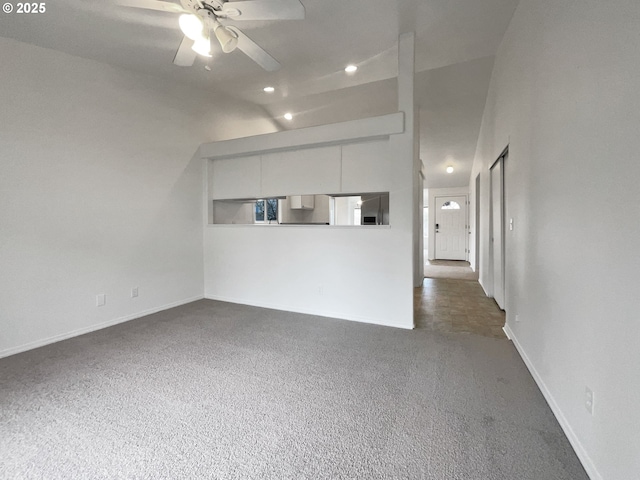 unfurnished living room featuring carpet flooring, ceiling fan, lofted ceiling, and baseboards