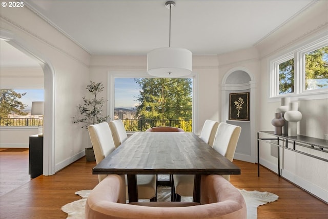 2869 SW Champlain Dr, Portland, OR 97205 - dining area with arched walkways, crown molding, and wood finished floors