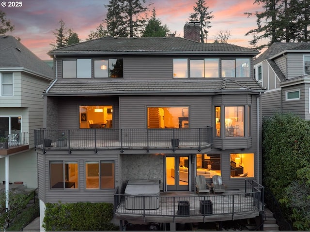 2869 SW Champlain Dr, Portland, OR 97205 - back of house at dusk featuring a chimney and a balcony