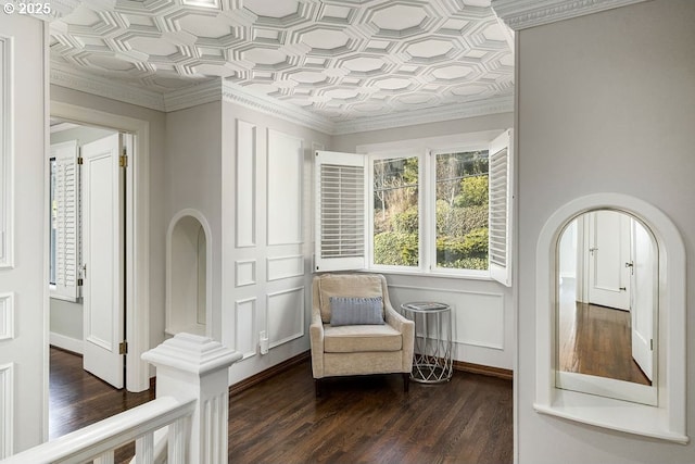 2869 SW Champlain Dr, Portland, OR 97205 - sitting room featuring dark wood-style flooring, baseboards, an ornate ceiling, ornamental molding, and arched walkways