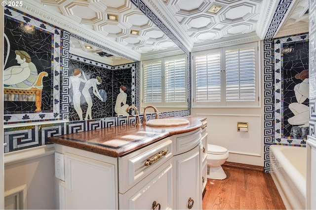 2869 SW Champlain Dr, Portland, OR 97205 - full bathroom with vanity, toilet, ornamental molding, wood finished floors, and baseboards