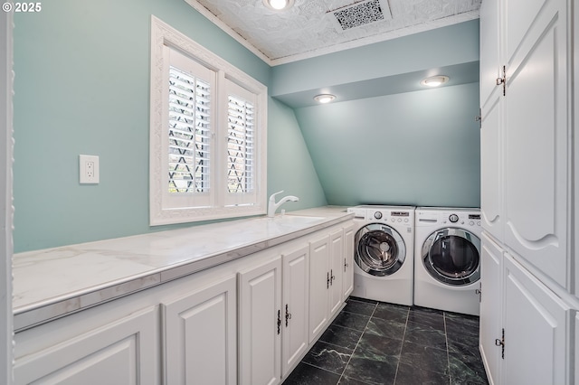 2869 SW Champlain Dr, Portland, OR 97205 - laundry area with washer and dryer, cabinet space, and dark marble finish floors