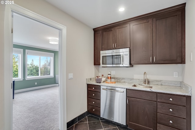2869 SW Champlain Dr, Portland, OR 97205 - kitchen with appliances with stainless steel finishes, a sink, dark brown cabinetry, baseboards, and recessed lighting