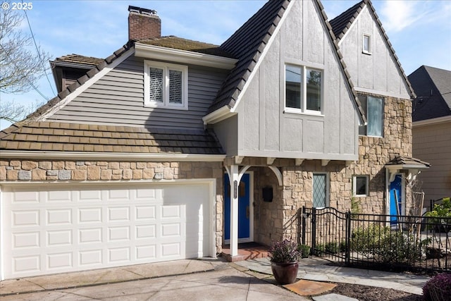 2869 SW Champlain Dr, Portland, OR 97205 - view of front facade with a chimney, stone siding, and driveway