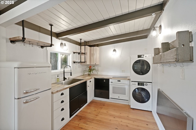28831 SE Woods Rd, Eagle Creek, OR 97022 - kitchen with white appliances, stacked washing machine and dryer, a sink, open shelves, and light countertops
