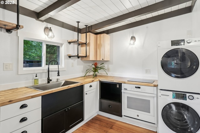 28831 SE Woods Rd, Eagle Creek, OR 97022 - kitchen featuring wood counters, white oven, stacked washer / drying machine, a sink, and wooden ceiling with exposed beams