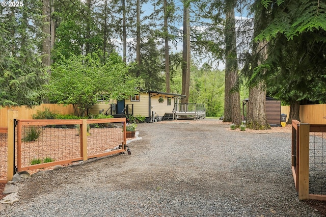 28831 SE Woods Rd, Eagle Creek, OR 97022 - view of front of home featuring a deck, driveway, and an outdoor structure