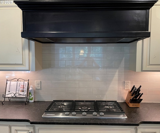 kitchen with white cabinetry, stainless steel gas cooktop, extractor fan, and tasteful backsplash
