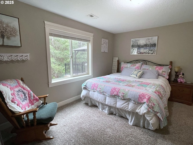 bedroom with carpet flooring, baseboards, and visible vents