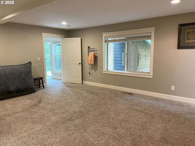 unfurnished living room with baseboards, recessed lighting, carpet, and visible vents