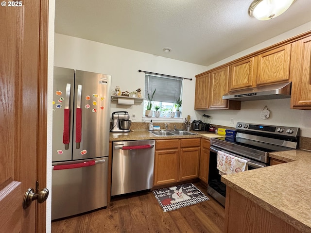 3125 NE Flintlock Pl, Corvallis, OR 97330 - kitchen featuring appliances with stainless steel finishes, under cabinet range hood, a sink, dark wood-style floors, and open shelves