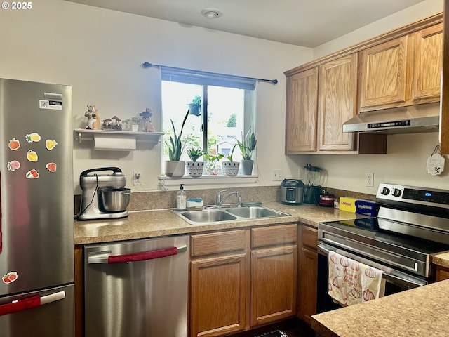 3125 NE Flintlock Pl, Corvallis, OR 97330 - kitchen with under cabinet range hood, stainless steel appliances, a sink, and light countertops