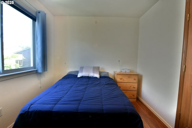 3125 NE Flintlock Pl, Corvallis, OR 97330 - bedroom with wood finished floors, multiple windows, and baseboards