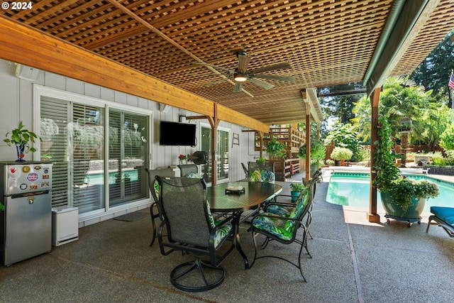 view of patio / terrace featuring stairs, outdoor dining area, and an outdoor pool