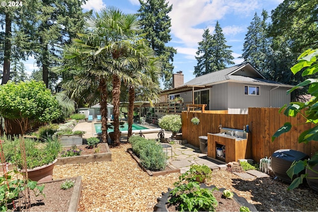 view of yard featuring fence private yard, a patio area, and a vegetable garden