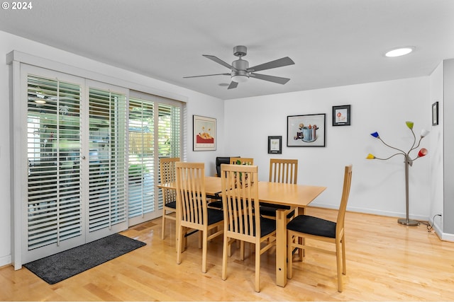 dining room with light wood-type flooring, ceiling fan, and baseboards