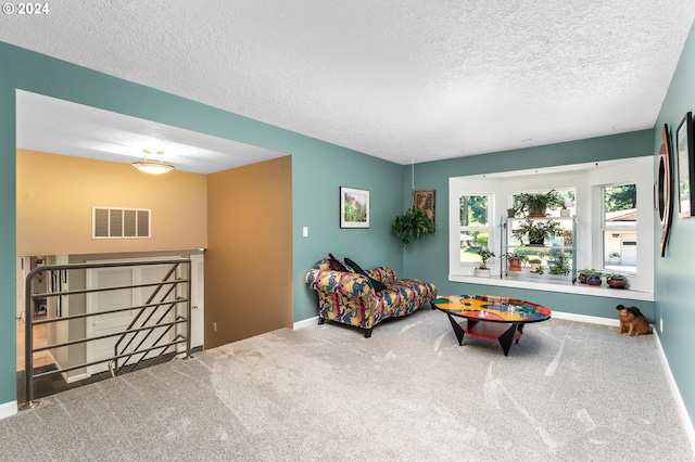 interior space featuring a textured ceiling, carpet flooring, visible vents, and baseboards