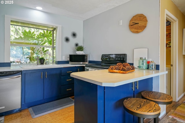 kitchen with stainless steel microwave, dishwashing machine, a peninsula, black electric range oven, and blue cabinets