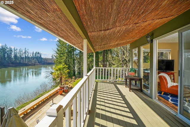 wooden terrace featuring a water view