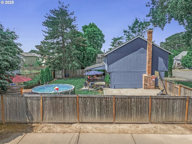 6516 SW Locust St, Portland, OR 97223 - exterior space with a fenced backyard, a patio area, and a chimney
